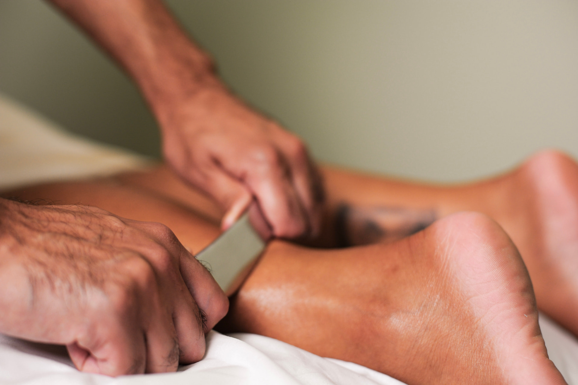 Instrument-assisted sports massage on the lower leg