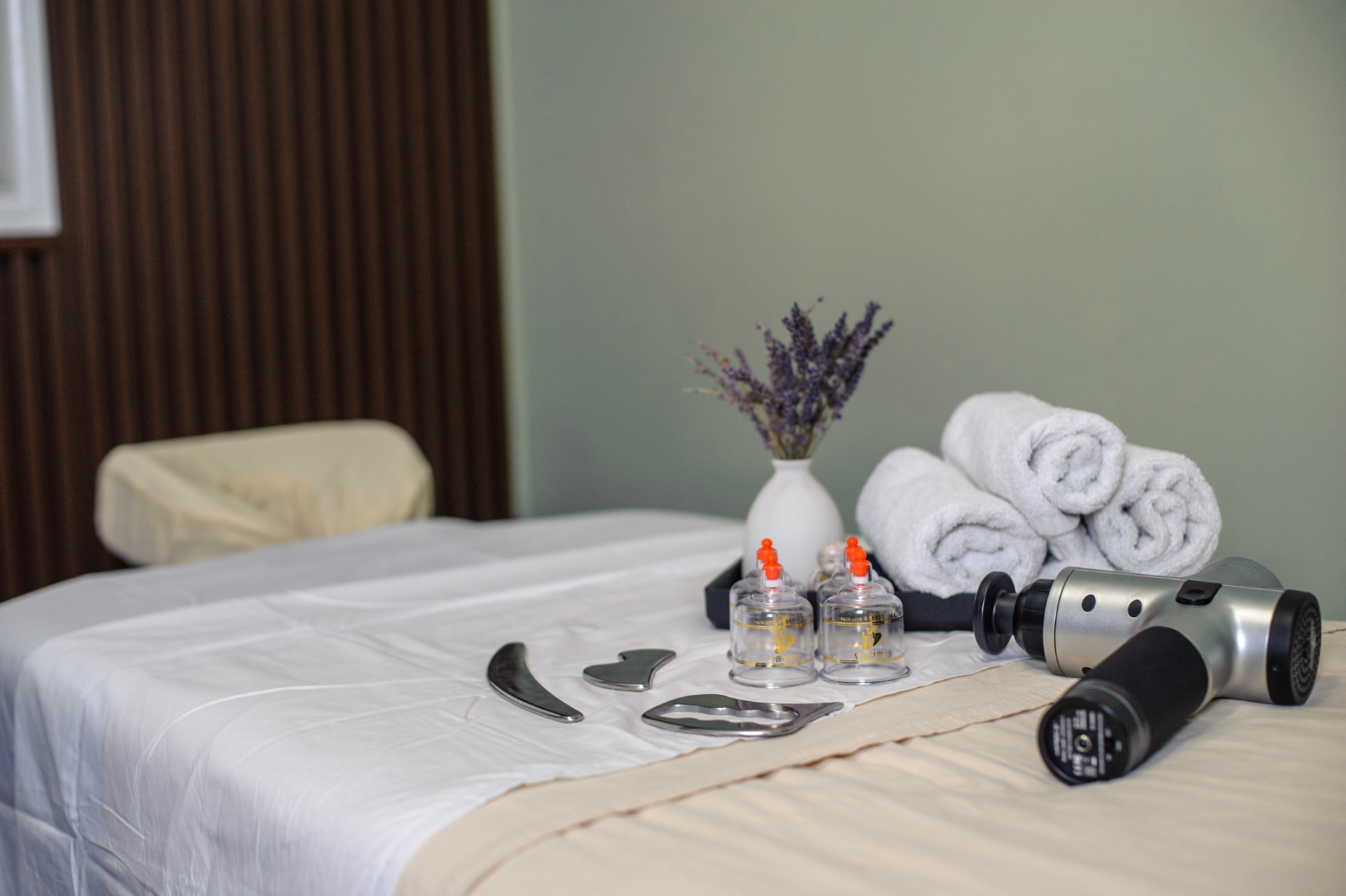 Treatment table set with towels, cupping set, and tools at Muscle Masters Therapy in Brampton